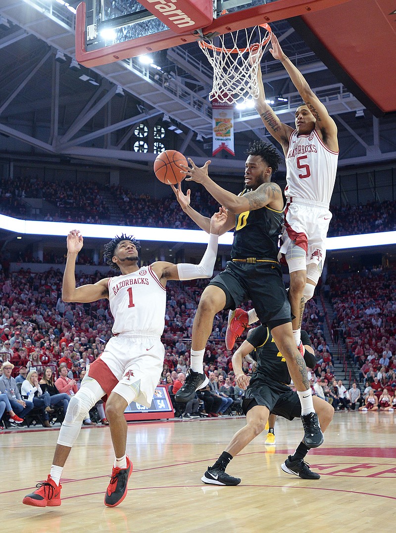Arkansas guards Isaiah Joe (1) and Jalen Harris (5) battle Saturday, Feb. 22, 2020, for a rebound with Missouri guard Torrence Watson (0) during the second half in Bud Walton Arena in Fayetteville. Visit nwaonline.com/uabball/ for a gallery from the game. (NWA Democrat-Gazette/Andy Shupe)