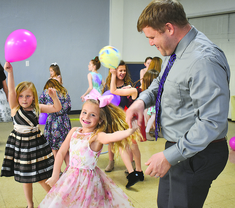 Kyle Stevens, left, dances with daughter Piper, 6, during Sunday's Immaculate Conception School Father-Daughter Dance. Piper, a ballet dancer, has been looking forward to the event. 