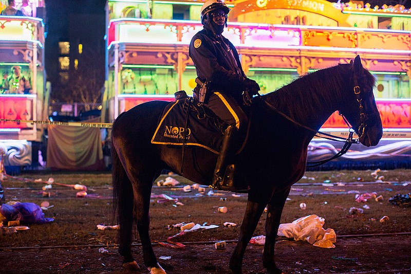 A police officer works the scene where a man was reportedly hit and killed by a float of the Krewe of Endymion parade in the runup to Mardi Gras in New Orleans, Saturday, Feb. 22, 2020. A person was struck by a float and fatally injured Saturday evening during one of the iconic parades of the Mardi Gras season in New Orleans, authorities said. It was the second death in days to mar this year's Carnival festivities. (Max Becherer/The Advocate via AP)