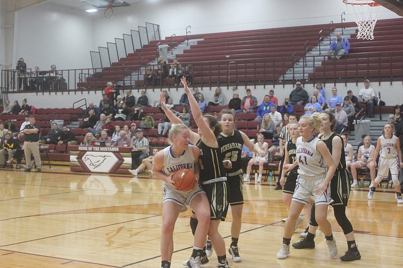 <p>Democrat photo/Kevin Labotka</p><p>Paige Lamm backs into a defender Monday during the Pintos’ win over Versailles in the first round of the Class 3 District 9 tournament.</p>