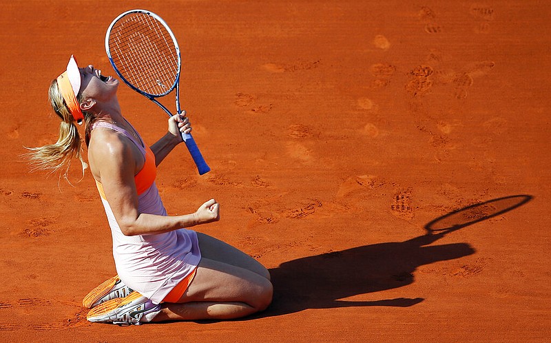 In this Jule 7, 2014, file photo, Russia's Maria Sharapova reacts after defeating Romania's Simona Halep during their final match of the French Open tennis tournament at the Roland Garros stadium, in Paris, France. Sharapova is retiring from professional tennis at the age of 32 after five Grand Slam titles and time ranked No. 1. She has been dealing with shoulder problems for years. In an essay written for Vanity Fair and Vogue about her decision to walk away from the sport, posted online Wednesday, Feb. 26, 2020, Sharapova asks: "How do you leave behind the only life you've ever known?" (AP Photo/David Vincent, File)