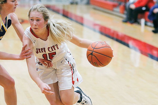 Brooke Bates of Jefferson City dribbles around a Hickman defender during Thursday night's game at Fleming Fieldhouse.