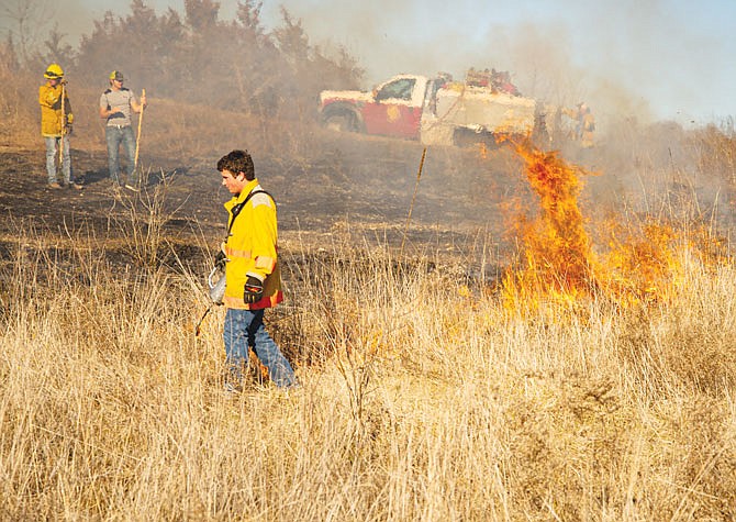 Firefighters from different Cole County fire protection districts set a fire line Saturday during training for prescribed brush cover fires.