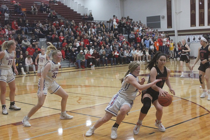 <p>Democrat photo/Kevin Labotka</p><p>Rylee Hees tries to knock the ball away from a Southern Boone player Feb. 28 during the Pintos’ game against the Eagles.</p>
