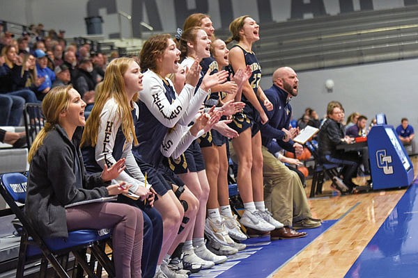 The Helias bench cheers after the Lady Crusaders score Monday night against Camdenton during the Class 4 District 10 Tournament semifinals at Capital City High School.