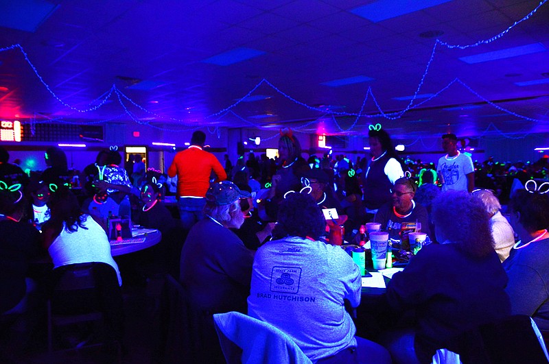 <p>People gather before starting a game of bingo at the 2018 Black Light Cosmic Bingo event at the St. Martins Knights of Columbus. This year’s event is set for March 21 and will benefit Central Missouri Honor Flight and the Community Breast Care Project. News Tribune file photo</p>