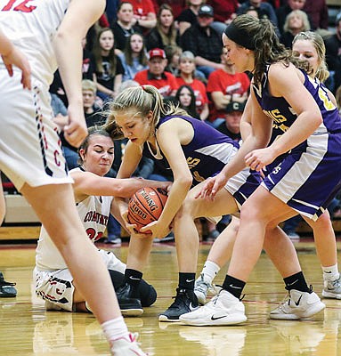 Ariel Owens of Chamois battles for a loose ball with Sadie Hoyt of Community during Tuesday night's Class 1 sectional game in Harrisburg.