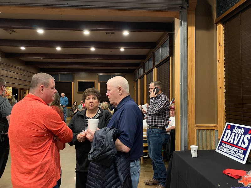 Chief Deputy Jeff Neal (far right) speaks on the phone while waiting on results Tuesday at the Silver Star Smokehouse in Texarkana, Texas.