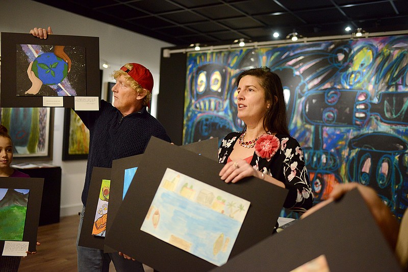 <p> News Tribune file</p><p>Artist Jim Dyke and Mayor Carrie Tergin hold up their favorite paintings as they judge the 2019 spring art contest at the Jefferson City Museum of Modern Art. The 2020 contest is open to students in third through eighth grades, and submissions must by entered by March 29.</p>