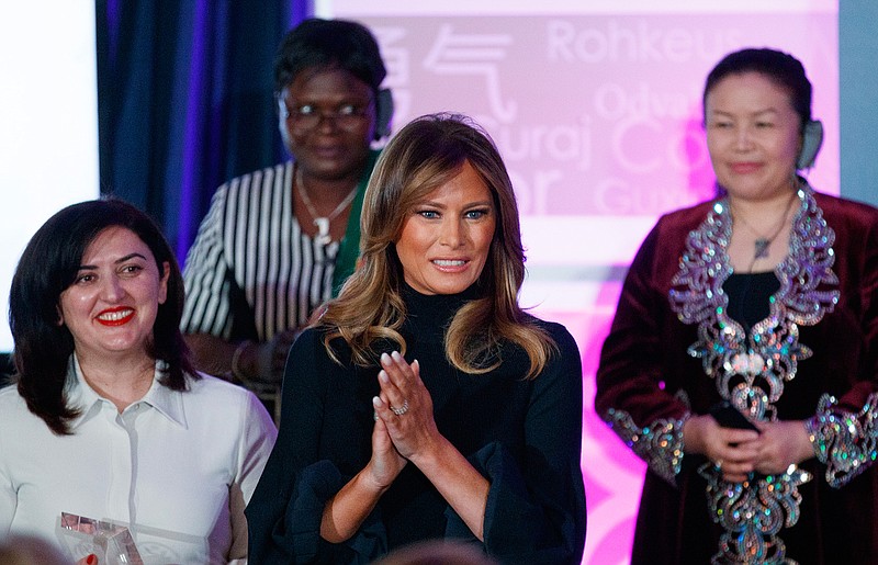 First lady Melania Trump arrives for the 2020 International Women of Courage Awards Ceremony at the State Department in Washington, Wednesday, Feb. 4, 2020. Also on stage from left are Shela Umbatova of Azerbaijan, Claire Ouedraogo of Burkina Faso, and Sayragul Sauytbay, of China  nominated by Kazakhstan.(AP Photo/Carolyn Kaster)