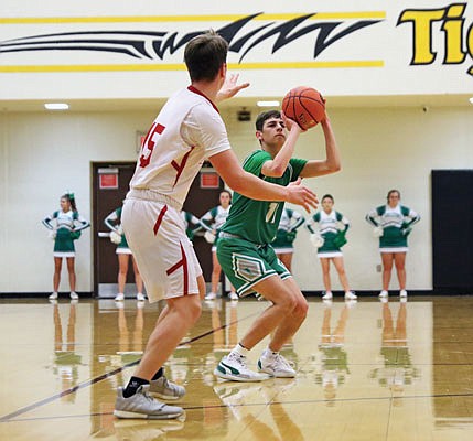 Quinn Kusgen of Blair Oaks pulls up for a 3-pointer as Butler's Bryce Miller defends during Wednesday night's Class 3 sectional game in Sedalia.
