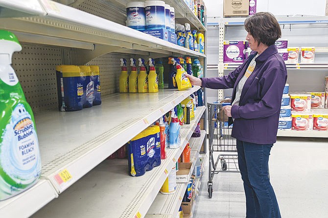 At Walmart, Karen Gruber looks over a shelf that was formerly full of disinfectant sprays and wipes. According to the CDC, cleaning frequently touched surfaces (such as doorknobs) is one way to prevent the spread of COVID-19.