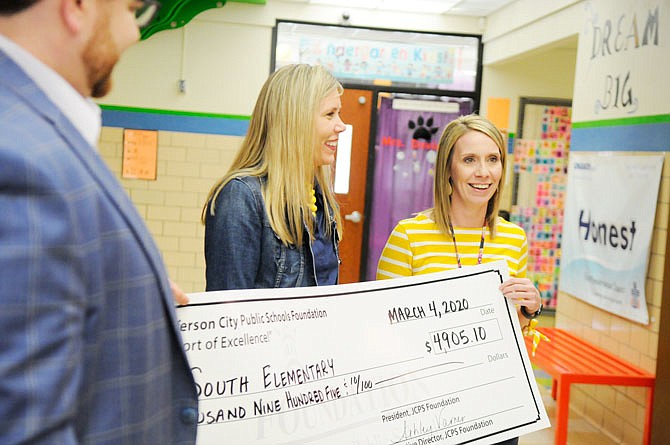 Jefferson City Public Schools Foundation presents a check to South Elementary Instructional Coach Carrie Martin.