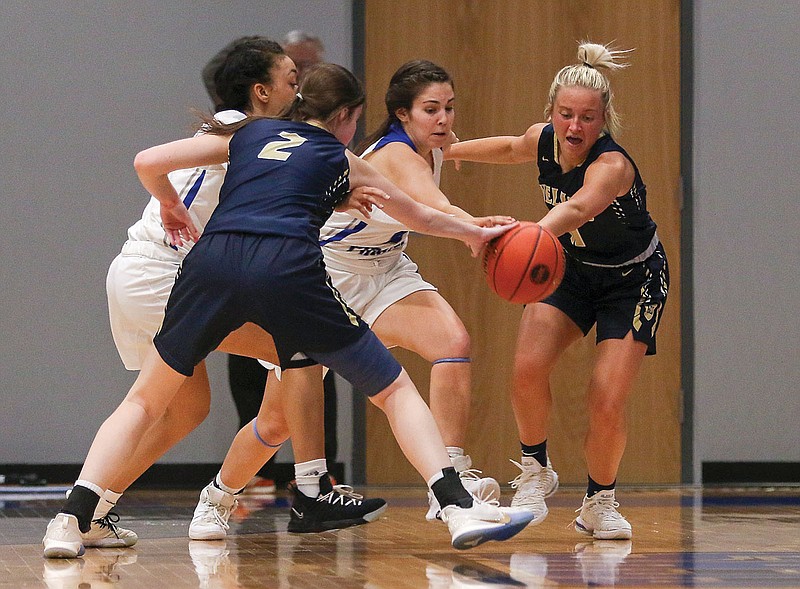 Helias' Emily Harrison (right) reaches for a loose ball during Thursday night's Class 4 District 10 Tournament title game against Boonville at Capital City High School.