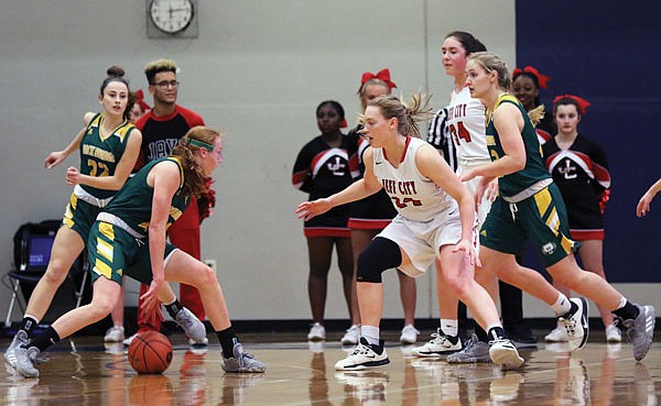 Averi Kroenke of Rock Bridge dribbles between her legs as Kara Daly of Jefferson City defends during Friday night's Class 5 District 9 Tournament championship game at Battle High School in Columbia.