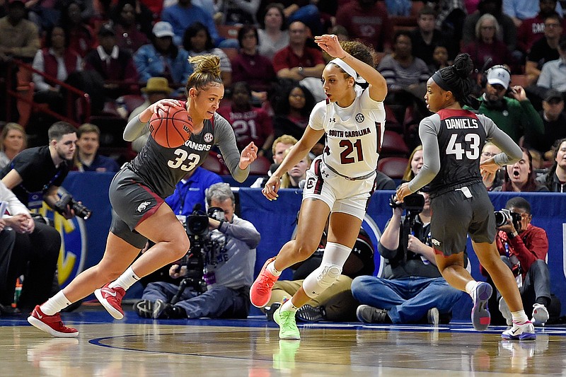 FILE — Arkansas guard Chelsea Dungee (33) drives against South Carolina's Mikiah Herbert-Harrigan during a semifinal match at the Southeastern conference women's NCAA college basketball tournament in Greenville, S.C., Saturday, March 7, 2020. (AP Photo/Richard Shiro)