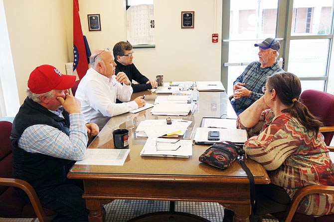 Callaway County Commissioners Randy Kleindienst, left, Gary Jungermann and Roger Fischer talk to Kent Wood and Sharon Lynch, of the Callaway County Health Department, about the potential COVID-19 response funding. The CCHD's top priority is keeping its staff healthy and available to fight the disease's spread.