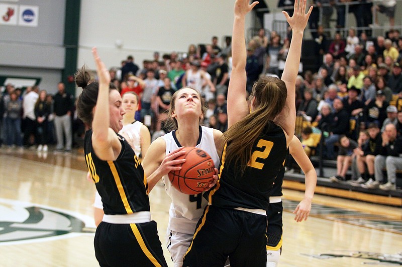 Kylie Bernskoetter (center) of Helias looks to take a shot between Sullivan's Kya Harbour (left) and Payton Dudley (right) during the second half of Tuesday night's Class 4 sectionals at Missouri S&T in Rolla.