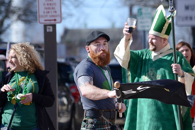 <p>Justin Boska, of Columbia, rolls up his Guiness flag after marching in the 2019 St. Patrick’s Day Parade in Jefferson City. This year’s parade is set for 2 p.m. Saturday, starting and ending at Paddy Malone’s Pub. News Tribune file photo</p>