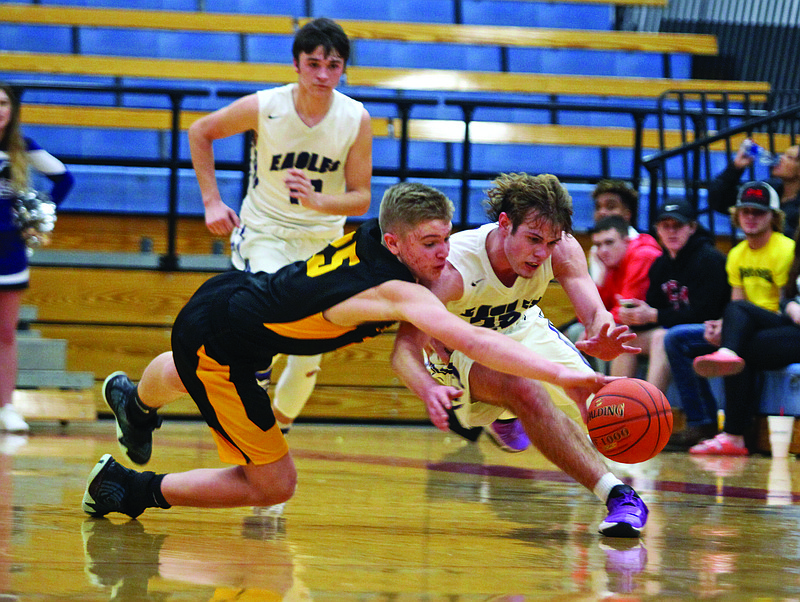 St. Elizabeth's Brock Lucas dives for a loose ball near mid-court against Meadville's Parker Burton during the second half of last Friday night's Class 1 quarterfinal game at Moberly Area Community College.