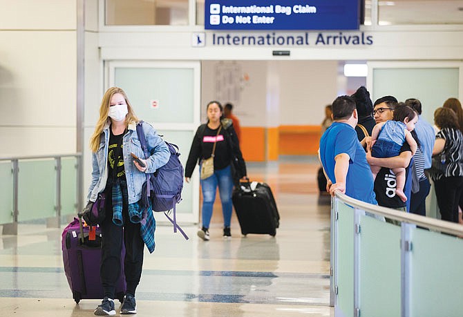 International travelers arrive Thursday at Terminal D at DFW International Airport. Travel from Europe has been restricted due to the spread of coronavirus. 