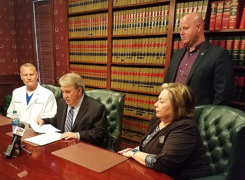 Dr. Matt Young, left; Bowie County Judge Bobby Howell; Fire Chief Eric Schlotter; and City Manager Shirley Jaster hold a news conference Friday, March 13, 2020, at Howell's law office in Texarkana, Texas. The city and county will enact their emergency management plan and open an operations center Monday in response to the spread of the new coronavirus.