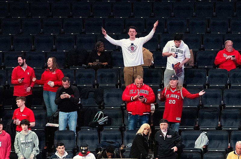 Fans react after the NCAA college basketball game between St. John's and Creighton in the quarterfinal of the Big East men's tournament was canceled at halftime Thursday, March 12, 2020, at Madison Square Garden in New York. (AP Photo/Mary Altaffer)