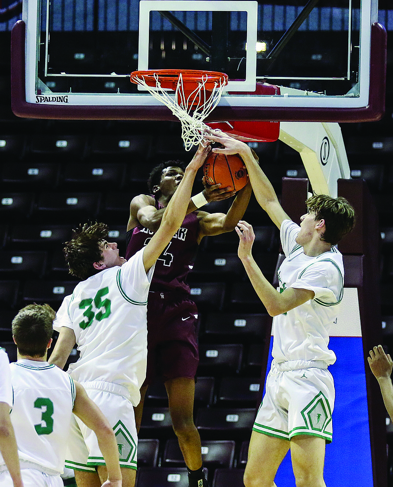 Blair Oaks teammates Eric Northweather (left) and Luke Northweather attempt to block a layup attempt by Brandon Ellington of Cardinal Ritter during Friday night's Class 3 state semifinal game at JQH Arena in Springfield.