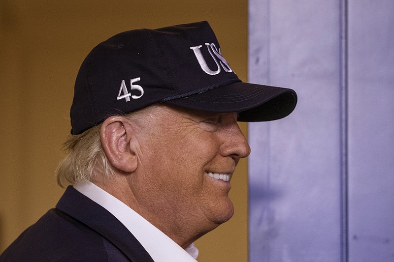 President Donald Trump talks about getting his temperature taken as he departs after speaking during a news conference about the coronavirus in the James Brady Briefing Room at the White House, Saturday, March 14, 2020, in Washington. (AP Photo/Alex Brandon)