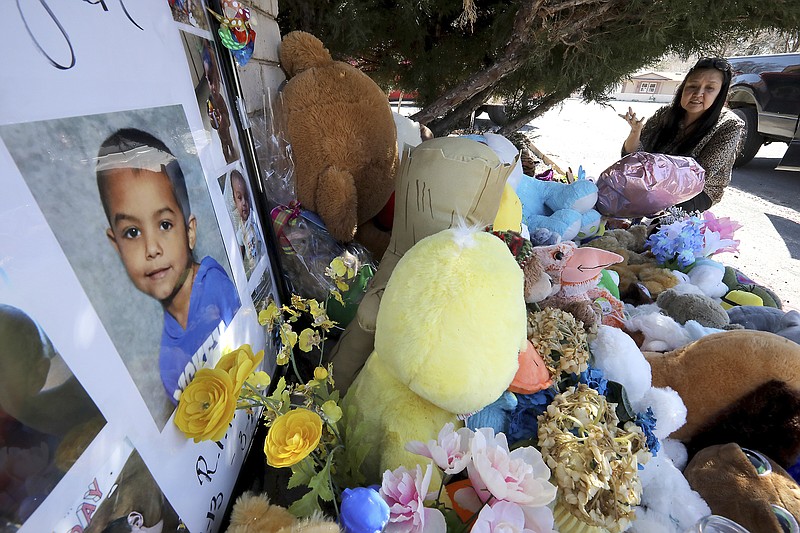 Wanda Ahasteen stops by a memorial for a 6-year-old boy in Flagstaff, Ariz., on Wednesday, March 4, 2020. Police have arrested the boy's parents and grandmother on suspicion of murder and child abuse in the boy's death. (Jake Bacon/Arizona Daily Sun via AP)