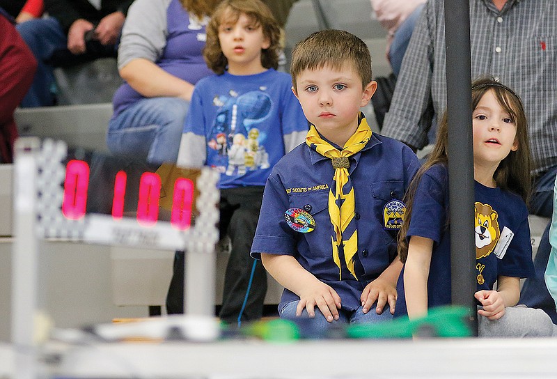 Trenton Fischer, left, and Allyson Branch watch intently as the championship race heats take place during the annual Five Rivers District Pinewood Derby at Blair Oaks Middle School. Trenton, from Scout Pack 96, and Allyson, from Scout Pack 332, placed first and second, respectively, in their Lion Den age group.