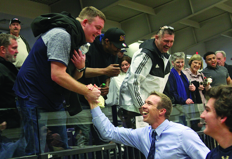 Helias boys basketball assistant coach Zach Rockers (right) shakes hands with Taylor Heislen after the Crusaders defeated Webb City during Saturday's Class 4 quarterfinal game at Southwest Baptist in Bolivar.