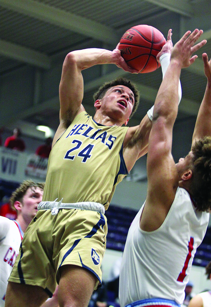 Marcus Anthony of Helias goes in for a layup against Webb City's Terrell Kabala during the first half of Saturday's Class 4 quarterfinal game at Southwest Baptist in Bolivar.
