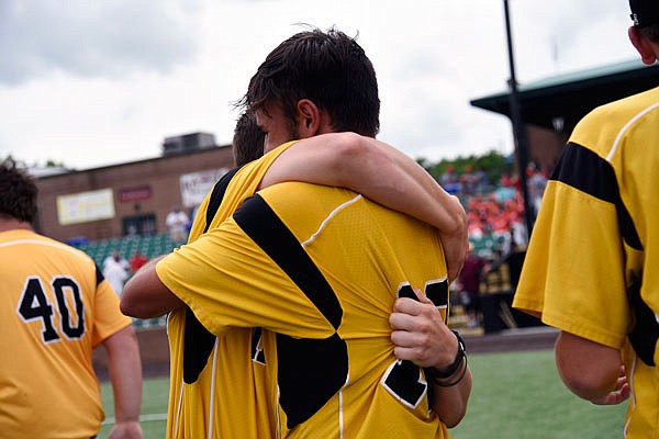 A pair of St. Elizabeth players embrace after the Hornets won the Class 1 state baseball title last June in O'Fallon.