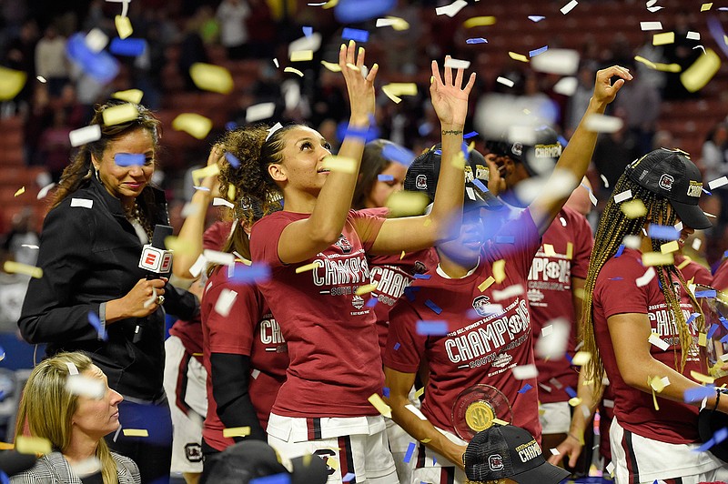 South Carolina's Mikiah Herbert-Harrigan grabs for confetti after defeating Mississippi State in a championship match at the Southeastern Conference women's NCAA college basketball tournament in Greenville, S.C., Sunday, March 8, 2020. (AP Photo/Richard Shiro)