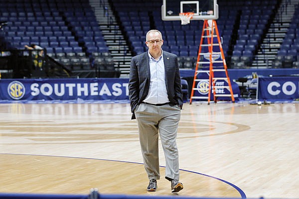 Southeastern Conference commissioner Greg Sankey walks across the basketball court as the venue is dismantled after the remaining games in the SEC Tournament were canceled last Thursday in Nashville, Tenn.