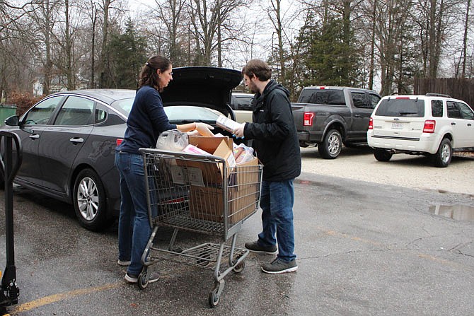 Diane Henry and Eric Morse load food items into a car at SERVE, Inc. Executive Director Courtney Harrison said Wednesday that demand at the pantry has exploded.