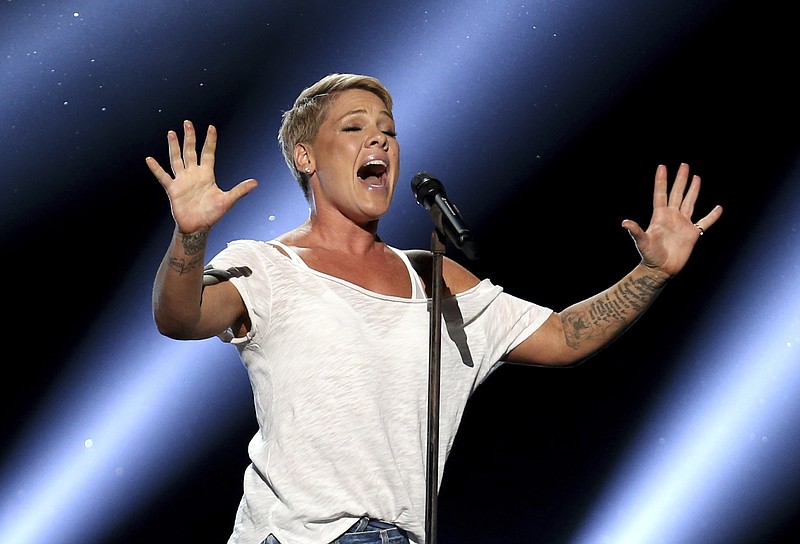In this Jan. 28, 2018, file photo, Pink performs "Wild Hearts Can't Be Broken" at the 60th annual Grammy Awards at Madison Square Garden in New York. The spreading coronavirus might have canceled several touring performances from A-list musical artists, but those acts have found a new venue to sing: their living rooms. Pink, John Legend, Bono, Coldplay's Chris Martin, John Mayer, Keith Urban and others have held virtual concerts from their homes as the world continues to practice social distancing to slow the spread of the virus. (Photo by Matt Sayles/Invision/AP, File)