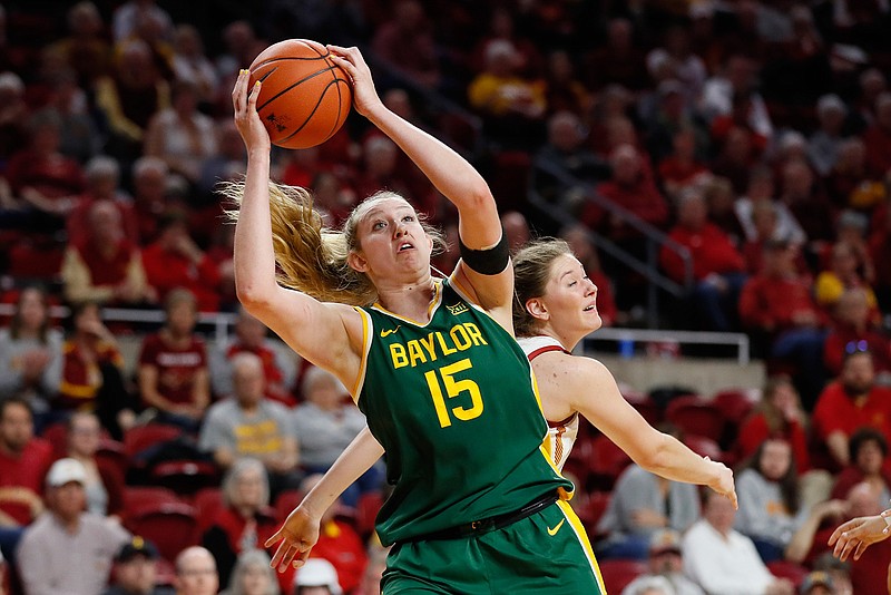In this Sunday, March 8, 2020 file photo, Baylor forward Lauren Cox (15) catches a pass ahead of Iowa State guard Ashley Joens, rear, during an NCAA college basketball game in Ames, Iowa. Lauren Cox is still trying to process that her college basketball career is over. The Baylor forward, like many other seniors, saw her season end when the NCAA Tournament was canceled. She was on a plane with her teammates ready to head to the Big 12 Tournament last week when word came that the conference had canned its postseason.(AP Photo/Charlie Neibergall, File)