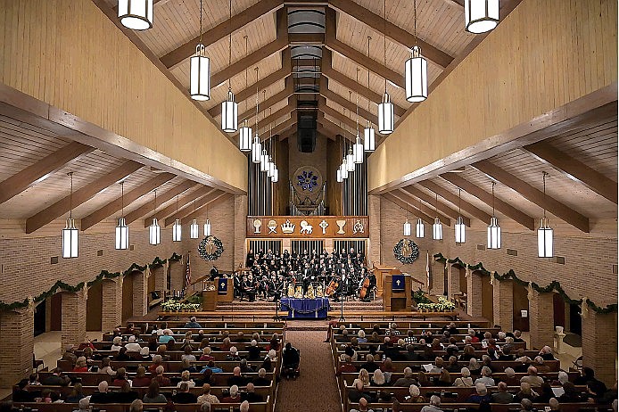 Audience members listen to Marc-Andre Bougie, conductor of the Texarkana Regional Chorale, talk about the program that the chorale is about to perform, "The Glory of Bach," on Dec. 10, 2019, at Williams Memorial United Methodist Church in Texarkana, Texas.