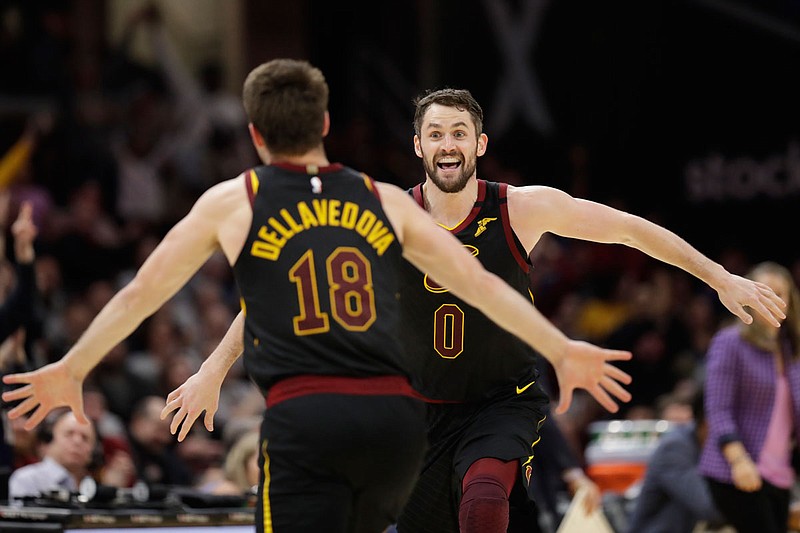 Cavaliers teammates Kevin Love and Matthew Dellavedova celebrate after Love made a 3-point shot in overtime of a March 8 game against the Spurs in Cleveland. 