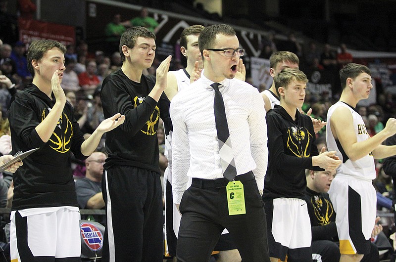 St. Elizabeth coach Dillon Tenholder celebrates in front of the bench during last season's Class 1 third-place game against Linn County at JQH Arena in Springfield.