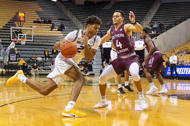Missouri's Tray Jackson dribbles around Southern Illinois' Eric McGill during the second half of a game Dec. 15, 2019, at Mizzou Arena in Columbia.