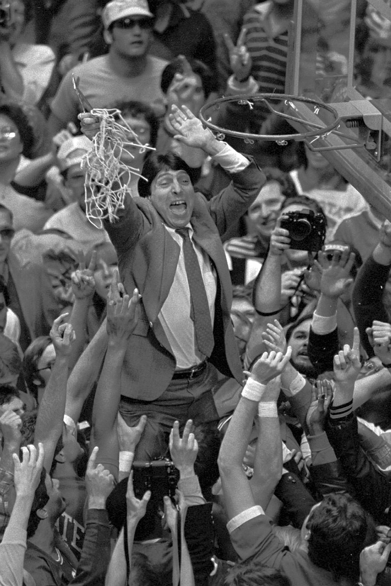 In this April 4, 1983 file photo, North Carolina State coach Jim Valvano holds the net aloft after his team defeated Houston 54-52 for the national championship in Albuquerque, N.M. 