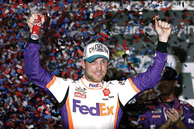 In this Feb. 17 file photo, Denny Hamlin celebrates in Victory Lane after winning the Daytona 500 at Daytona International Speedway in Daytona Beach, Fla. NASCAR introduced the country to iRacing on Sunday with some of the sport's biggest stars as Hamlin, the three-time Daytona 500 winner, beat Dale Earnhardt Jr. off the final corner at virtual Homestead-Miami Speedway to win the bizarre spectacle.