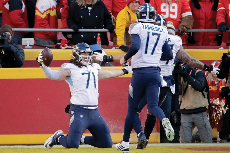 In this Jan. 19 file photo, Titans offensive tackle Dennis Kelly (71) celebrates his touchdown catch with quarterback Ryan Tannehill during the first half of the AFC Championship game against the Chiefs in Kansas City.