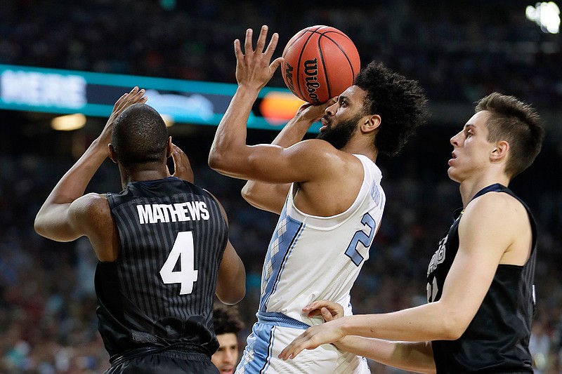 North Carolina's Joel Berry (2) takes a shot between Gonzaga's Jordan Mathews (4) and Zach Collins during the first half in the finals of the Final Four NCAA basketball tournament on April 3, 2017,  in Glendale, Ariz. North Carolina defeated Gonzaga 71-65. Berry was named MVP.  