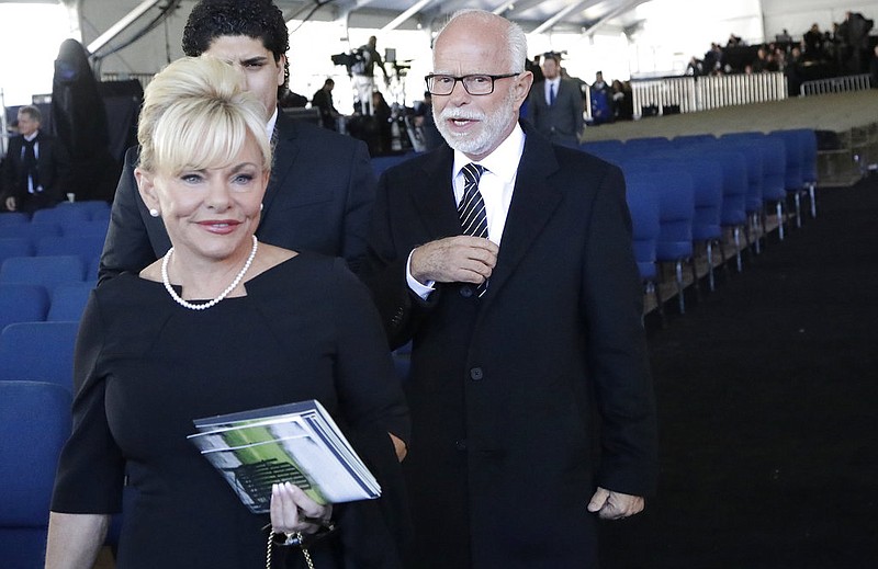 Televangelist Jim Bakker, right, walks with his wife Lori Beth Graham after a funeral service at the Billy Graham Library for the Rev. Billy Graham, who died at age 99, Friday, March 2, 2018, in Charlotte, N.C. (AP Photo/Chuck Burton)