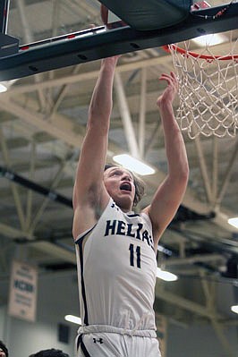 Caleb Justice of Helias shoots a layup during the first half of a Class 4 sectional game earlier this month against Rolla at Missouri S&T in Rolla.