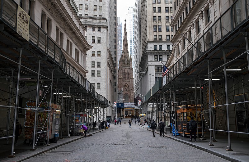 FILE - In this Monday, March 16, 2020, file photo, pedestrian traffic is light along Wall Street in Lower Manhattan in New York. The banking system is not as risk of failing as banks have plenty of capital on hand to handle this crisis due to the new coronavirus, economists say. (AP Photo/Craig Ruttle, File)